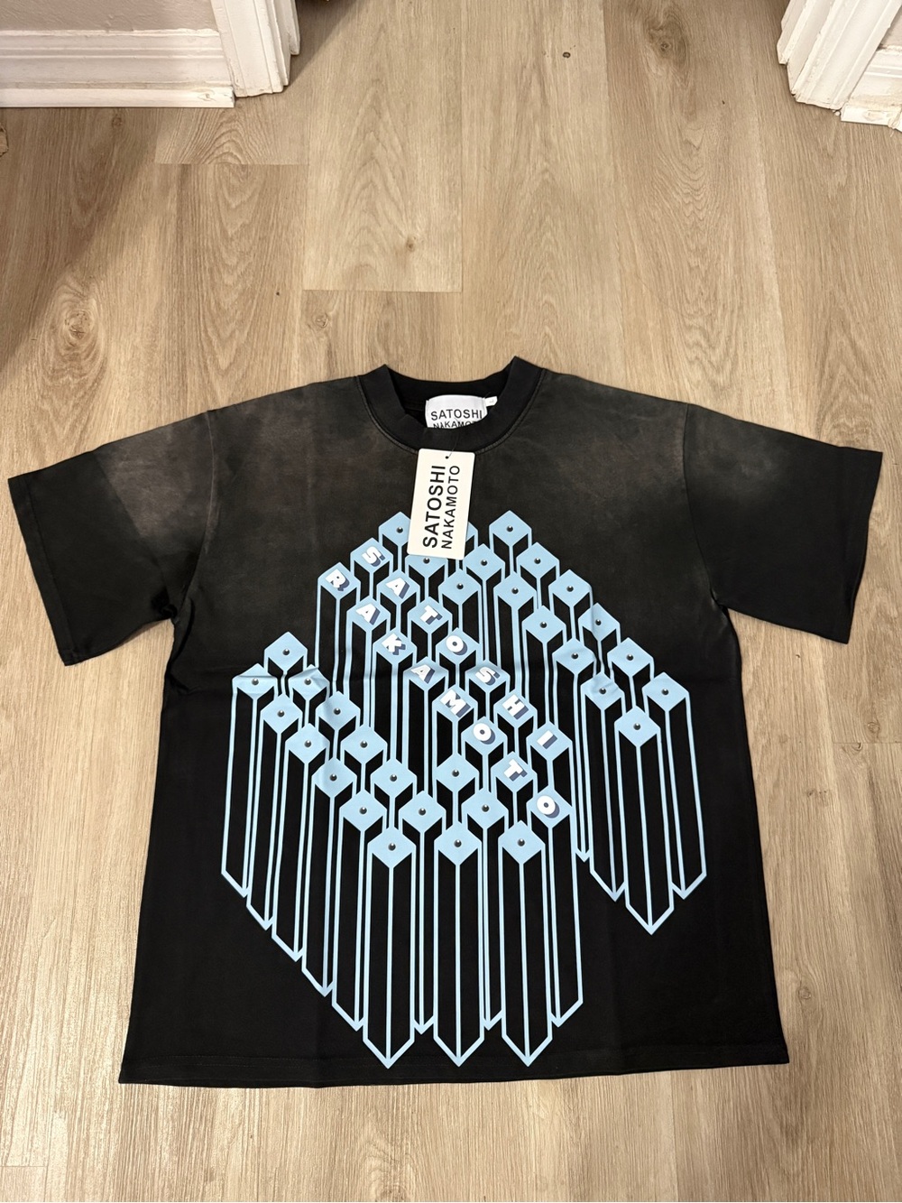 Satoshi Nakamoto - “Rakamoto” Men's Black Tee with Light Blue Geometric Print L